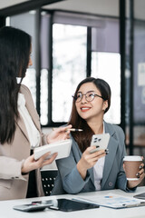 financial asian advisor showing plan of investment to clients in the consultancy office.