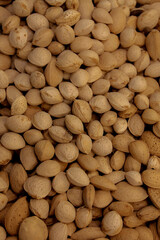 Creative layout made of almond nuts, Flat lay almond, Food concept, Almond pattern concept, natural texture and warm brown hues of the almonds, Healthy organic whole almonds nuts top view.
