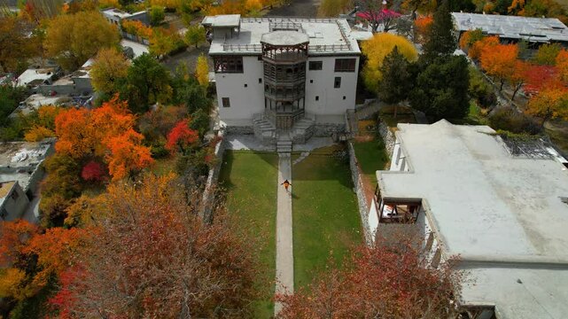 Drone shot of man running towards Khapalu Palace in joy at Khaplu Town in Pakistan.