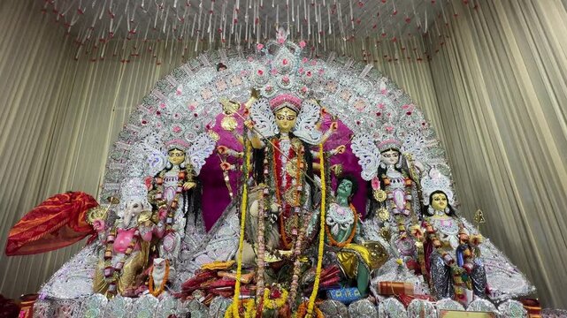 Profile view of Goddess Durga Idol decorated with jewellery and flowers during Durga Puja in Kolkata, India.