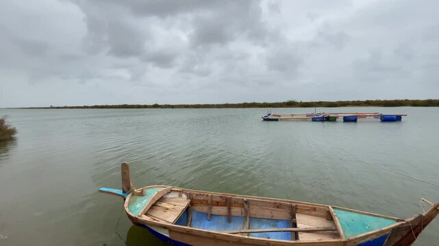 View of fisherman boats halted on ocean on a cloudy day in Keti Bandar village in Sindh, Pakistan.