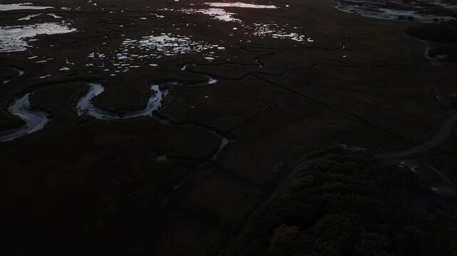Salt marsh landscape at sunset with winding water channels in Cape Cod, Barnstable, Massachusetts