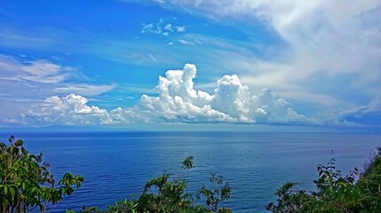 The captivating combination of a blue sky with fluffy white clouds, the vast expanse of the sea, and the vibrant green plants, enjoy the tranquility of nature.Generative AI