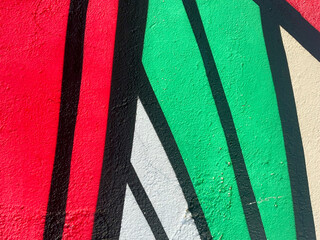 Vibrant Street Art Graffiti Close-Up with Straight Black Lines and Red and Green Details