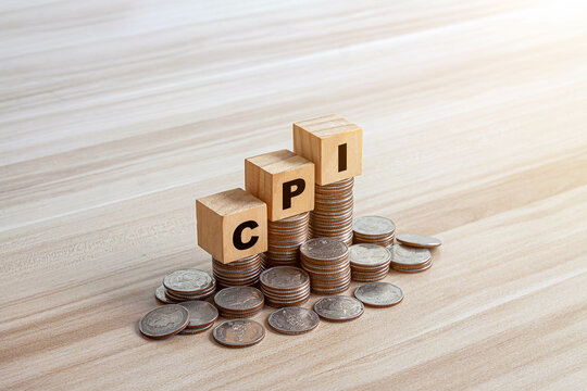 CPI, consumer price index symbol. Wooden blocks with words CPI, consumer price index on dollar bills with a calculator, coins. Business and CPI, Business and consumer price index concept.