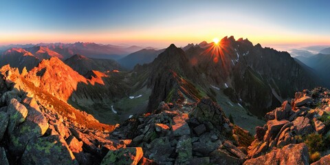 Sunset Over Mountain Peaks – A Dramatic and Stunning View from the Summit