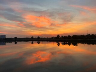 Beautiful evening sky with sunset reflecting on the calm water surface.
