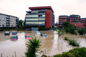 Suburban street with cars under the flood water
