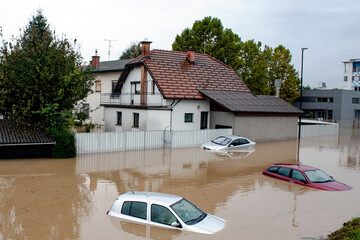 houses and cars under the water floods after heavy rain storm