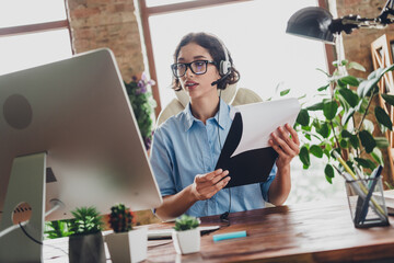 Photo of charming lady assistant wear shirt eyeglasses headphones preparing documents modern device...