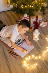 Boy writing letter to Santa Claus