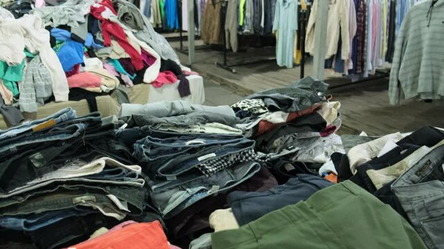 Pile of Assorted Secondhand Pants and Clothing in Thrift Store Display