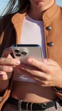 Young woman using smartphone,fingers scrolling and tapping screen