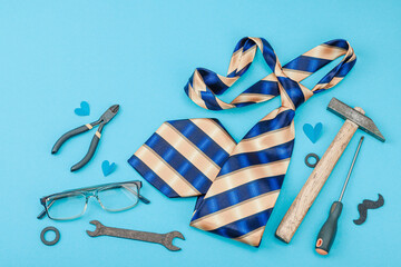 Happy Fathers Day concept. Set of manual tools, tie, spare parts, traditional symbols