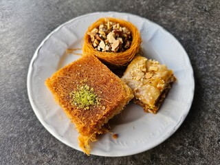 top view of syrian sweets served in a white plat