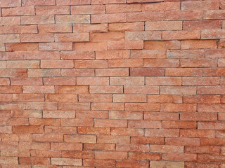 Red brick wall texture background with weathered bricks, cement joints, and an aged, grungy appearance. Ideal for architectural, urban, or vintage design projects.