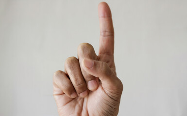 Close-Up of Raised Index Finger: A close-up of a hand raising a single index finger in an 'Aha!' gesture, with a subtle glowing effect around it