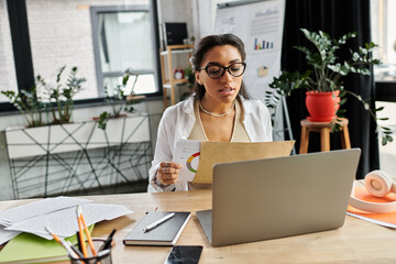 A young professional reviews documents and data while engaged in her work at a stylish office.