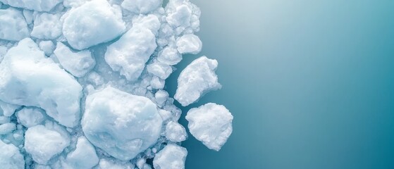 Fototapeta premium A collection of ice cubes afloat on a body of water against a backdrop of a clear blue sky