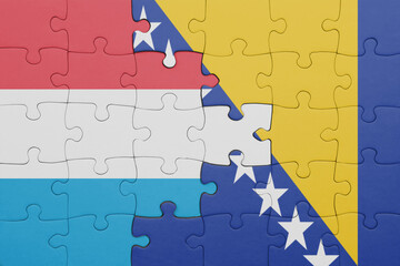 puzzle with the colourful national flag of luxembourg and flag of bosnia and herzegovina .