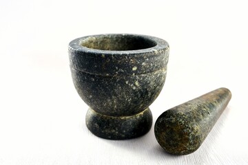 Stone mortar with pestle on white background