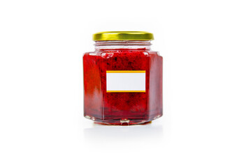 Hexagonal glass jar of homemade red currant berry or cranberry jam with a gold lid and blank label. Isaolated on white background. Copy space.