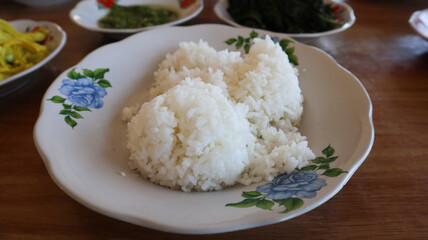 white rice at wite plate at Minang restaurant