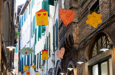 drawn objects hanging between houses