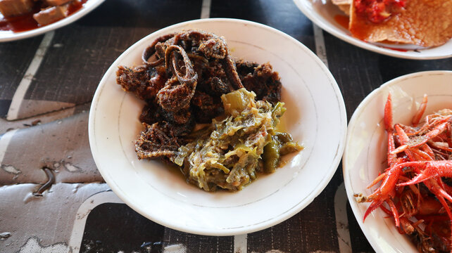 belut goreng. indonesian food from eel fish served with sambal hijau. Belut Goreng cabe hijau or Green chili fried eel