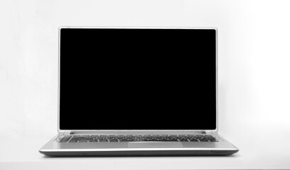 black mockup screen, mockup template monitor. one alone Laptop mock up standing on table in room, office isolated on white wall background. grey, gray notebook personal computer PC. front side view