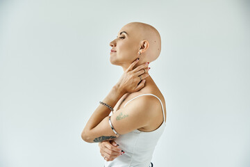 A lively young bald woman expresses self acceptance and strength, radiating confidence.
