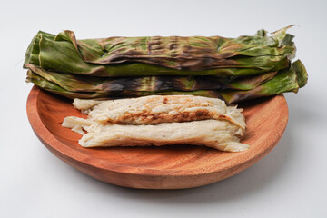 Otak-otak is a dish made from minced mackerel wrapped in banana leaves, grilled, and served with...