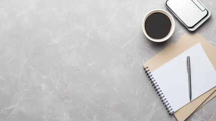 A stylish workspace featuring a notebook, pen, coffee cup, and paper on a textured surface.