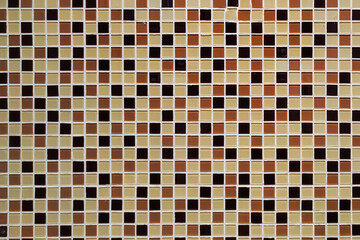 colorful small square of ceramic tile on the wall. brown and white mosaic pattern