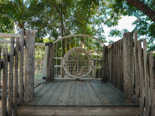 Summer park playground with swings, slides and climbing equipment. Modern wooden playground equipment for children's amusement park.