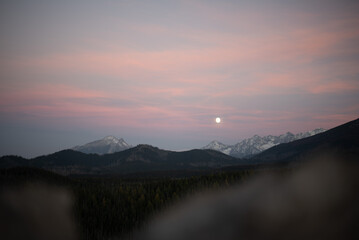 The sunset atop Mount Kopieniec in Zakopane, Poland, casts a warm glow over the Tatra Mountains, creating a stunning landscape 