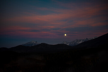The sunset atop Mount Kopieniec in Zakopane, Poland, casts a warm glow over the Tatra Mountains