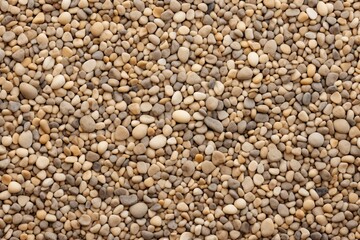 Natural assortment of small pebbles on the ground in a coastal area during daylight hours