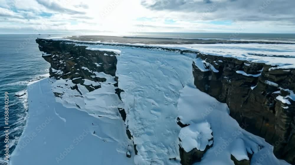 Poster snowcovered cliffs with a deep crevice overlooking a vast ocean.