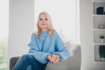 Portrait of nice aged lady sit cozy chair chill wear sweater pastime weekend modern flat indoors