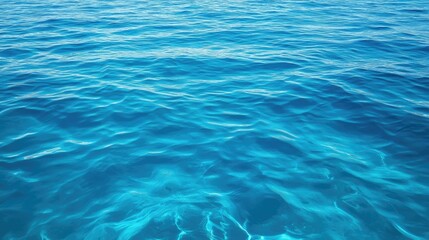 Obraz premium Aerial perspective of tranquil water waves in the sea highlights the vibrant turquoise hues, creating a serene ocean water background with ample copy space for design needs.