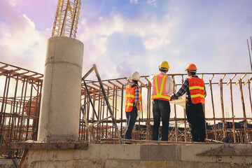 Structural engineer or architect and foreman worker with blueprints discuss, plan working for the outdoors building construction site. Construction collaboration concept