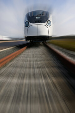 Front view of a Talgo high-speed train with motion simulation