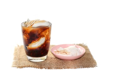Americano ice coffee serving with coconut water and coconut slices put on sack in white background, isolate concept.