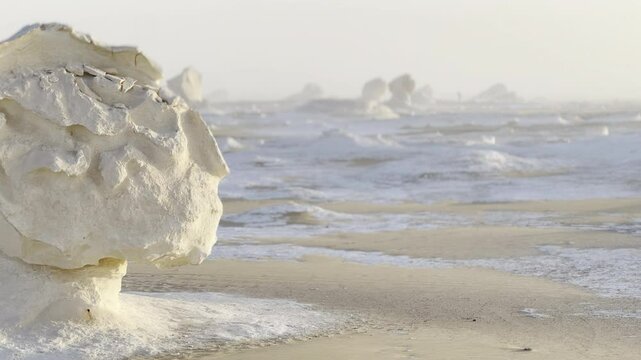 The Egyptian white desert adventure tourism with bedouin camping and 4x4 driving through the desert to see rock formation and sand and dust at sunset and golden hour