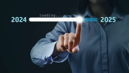 Woman touch on loading progress from 2024 to 2025 - copy space and bokeh for preparation merry Christmas and happy new year concept.