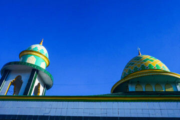 view of the dome and minarets of the mosque, against the blue sky