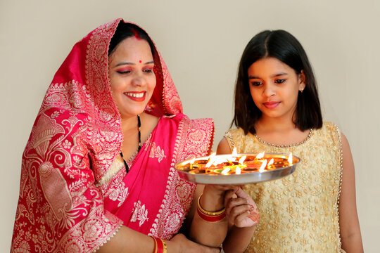 Sharing laughter and light, making Diwali moments unforgettable. A playful moment of joy and warmth this Diwali. Lighting up Diwali with smiles and laughter.