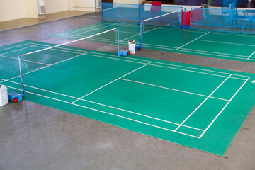 badminton field with green paint indoors, suitable place for sports