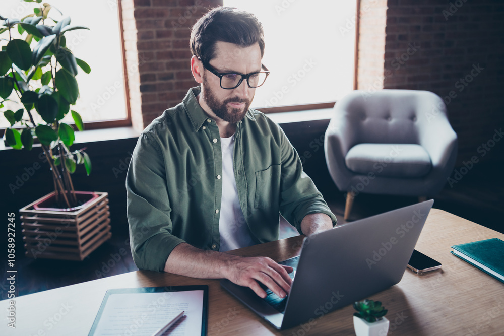 Wall mural Photo of confident cool boss wear shirt texting apple samsung modern device indoors workplace workstation